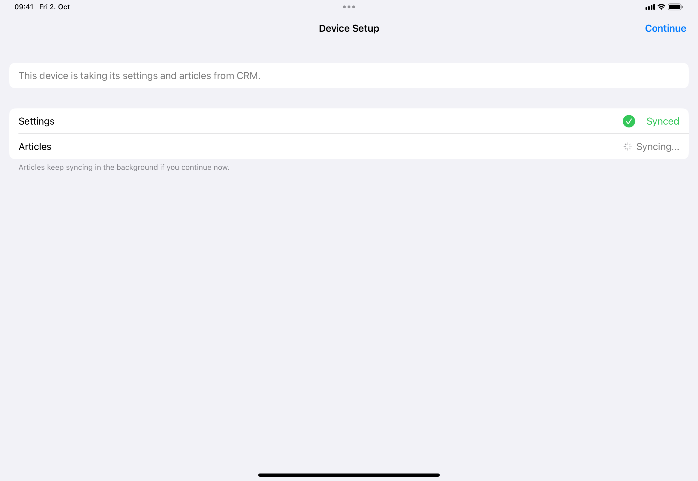 The Device Setup screen: Settings shows Synced, Articles shows Syncing…, and Continue is in the top right.